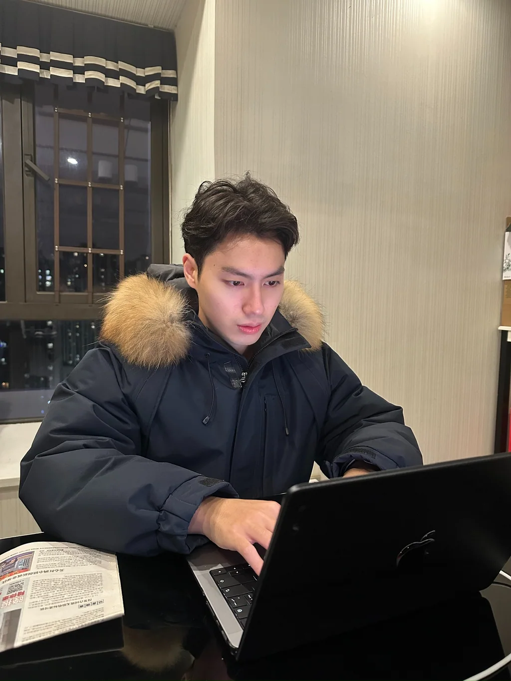 Wynn working at night while balancing graduate study and class responsibilities