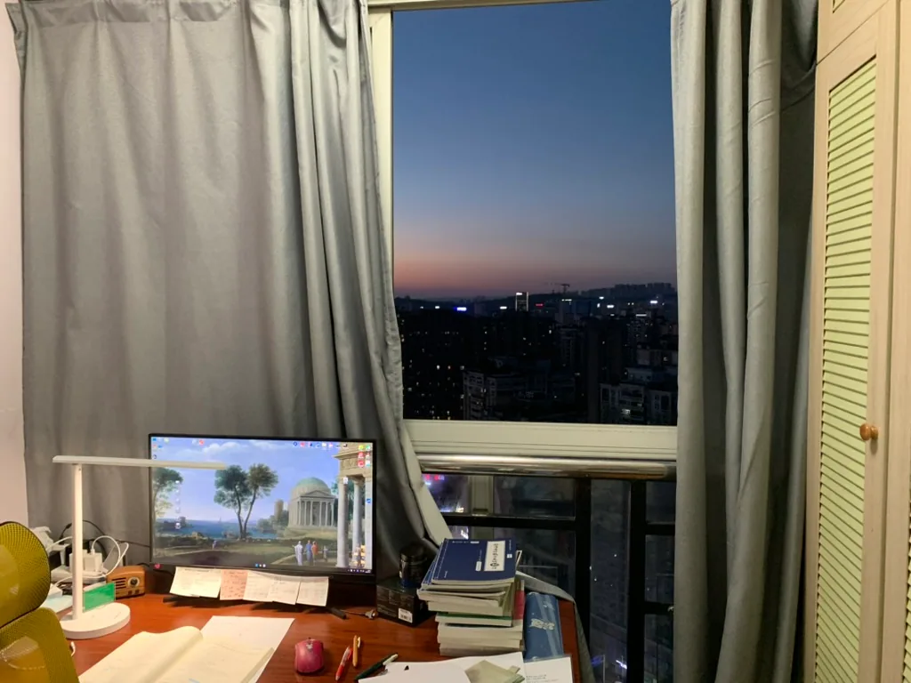 An evening study desk overlooking the city after work