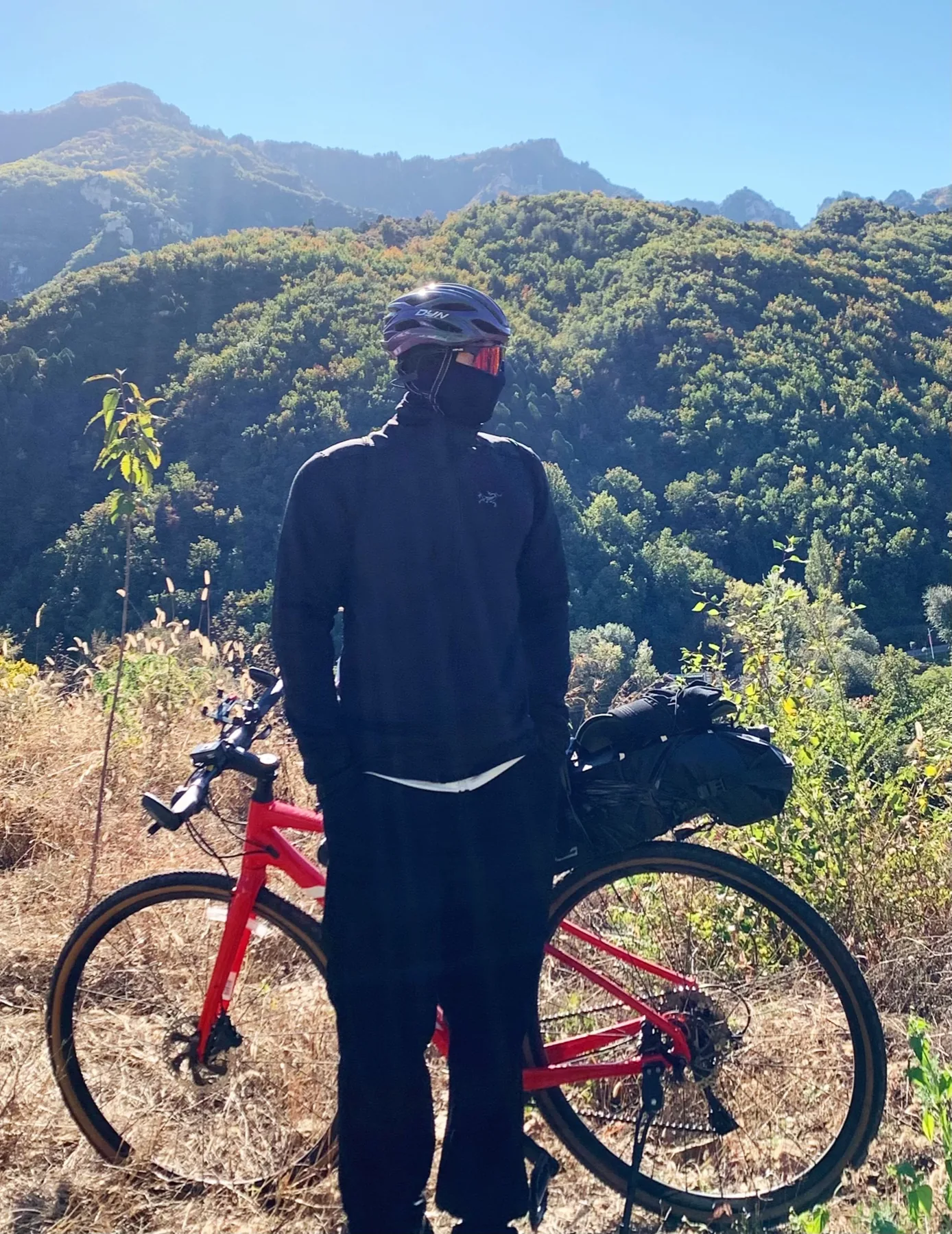 Wynn with a bicycle in the mountains