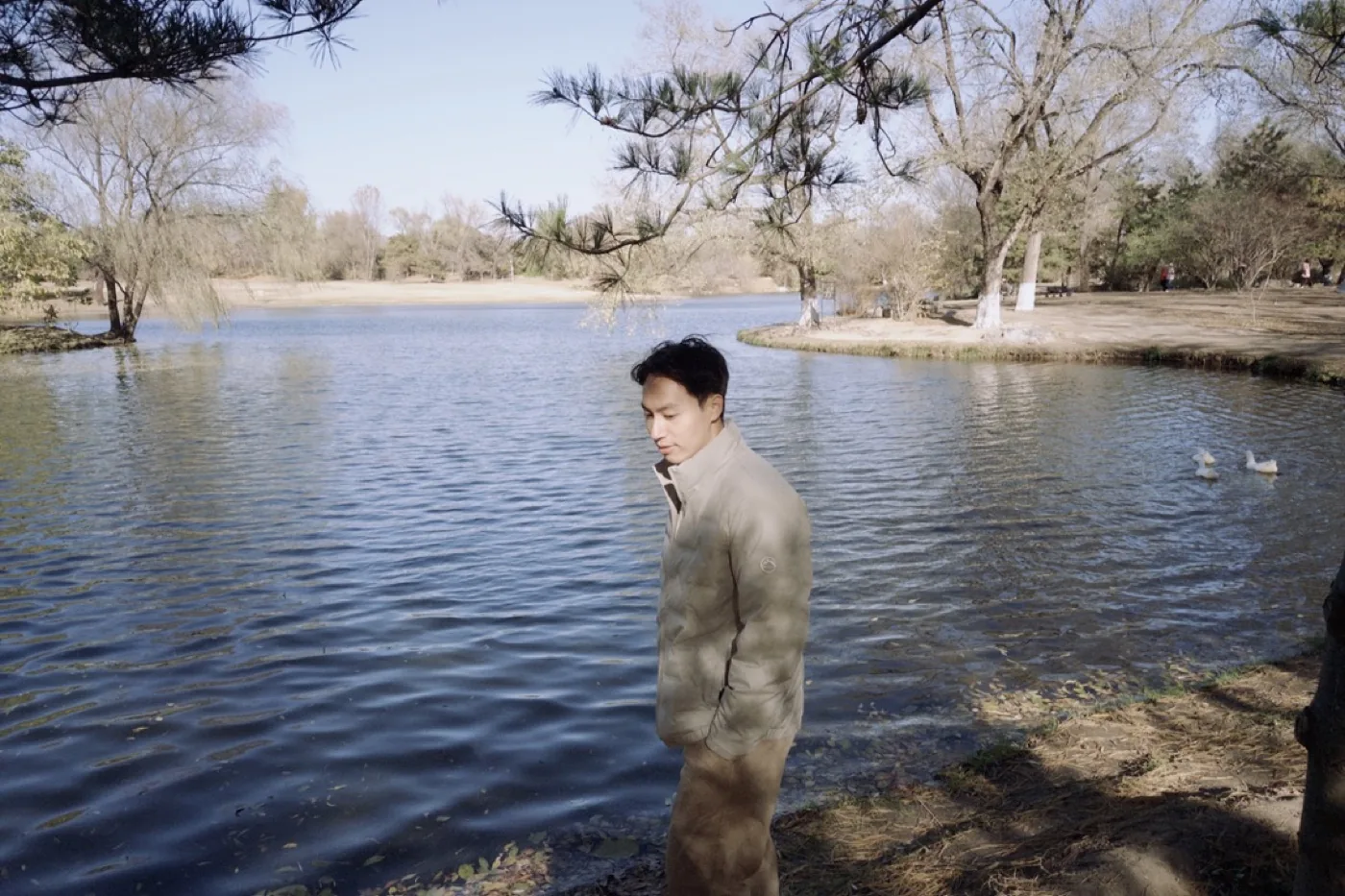 Wynn standing beside a lakeside